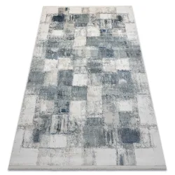 Covor geometric modern albastru cu ciucuri, ideal pentru decorul livingului